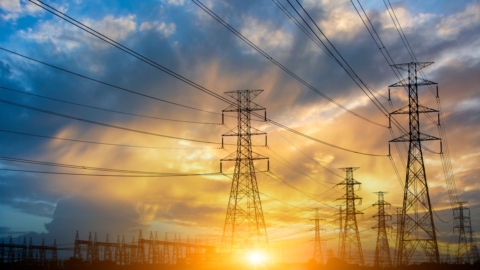 transmission power lines with sun set